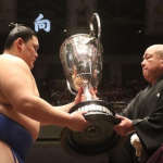 Sumo wrestler Onosato receives the Emperor's Cup after winning the 2024 aki basho in Tokyo, Japan.