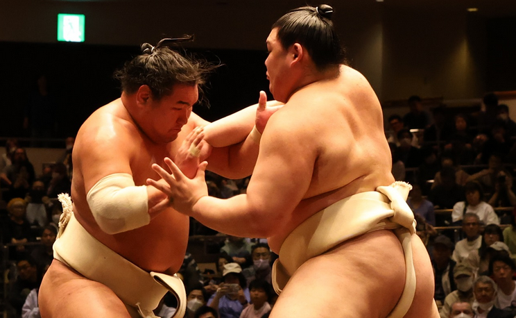 Sumo wrestlers Hoshoryu (left) and Onosato clash during an all stables practise in May 2025.
