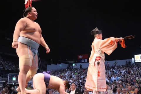 Sumo wrestler Kotoshoho stands over Aonishiki after he won the 2025 Nagoya basho.