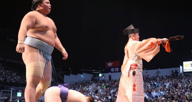 Sumo wrestler Kotoshoho stands over Aonishiki after he won the 2025 Nagoya basho.
