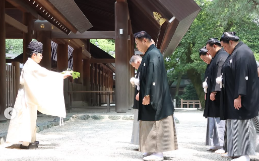 Sumo yokozunas Hoshoryu and Onosato and ozeki Kotozakura performing a ritual at the Atsuta shrine in Nagoya.